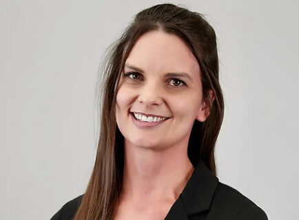 Smiling professional woman in black blazer