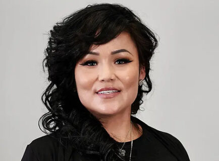 Smiling woman with dark curly hair