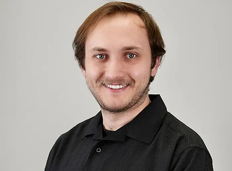 Smiling man in black collared shirt