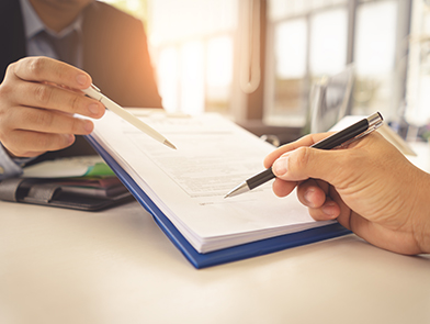 Professionals reviewing contract for signature
